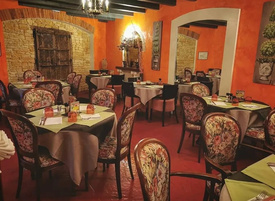 La salle aux murs de pierre et aux fauteuils fleuris